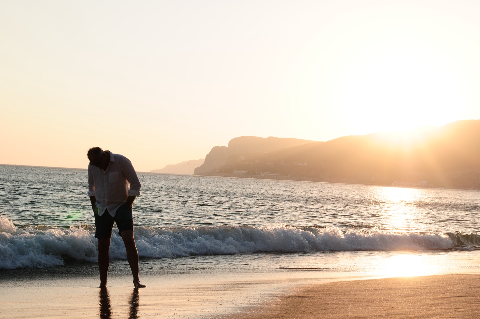 Mark Elliot walking on the beach at sunset